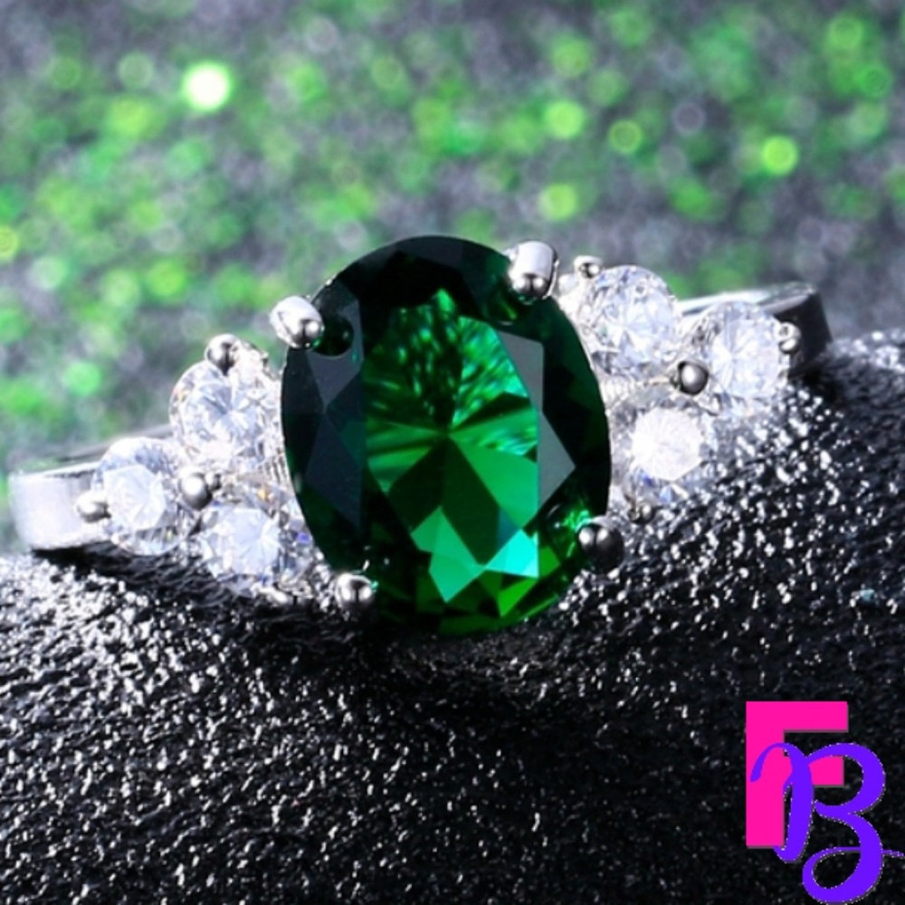 Emerald Green Oval Solitaire Ring with Side Stones